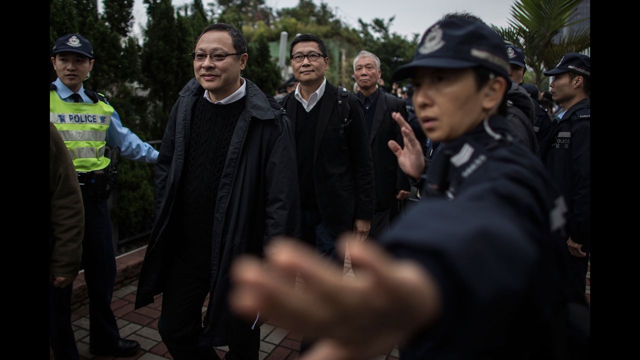 The three co-founders of the Occupy Central movement -- from left, Benny Tai Yiu-ting, Chan Kin-man, and the Rev. Chu Yiu-ming -- surrender to authorities in Hong Kong on Wednesday, December 3.