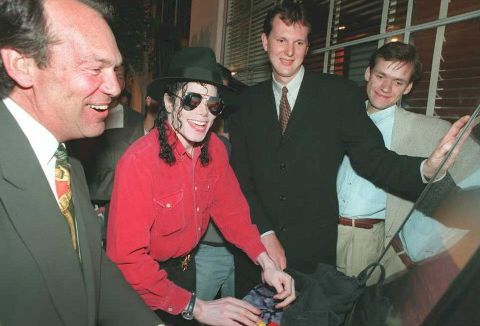 Pop superstar Michael Jackson plays Sony's then-new PlayStation in May 1995 as Sony Corp of America CEO Michael Schulhof, left, and Phil Harrison of Sony Computer Entertainment-Europe look on. This photo was taken at the Electronic Entertainment Expo in Los Angeles.