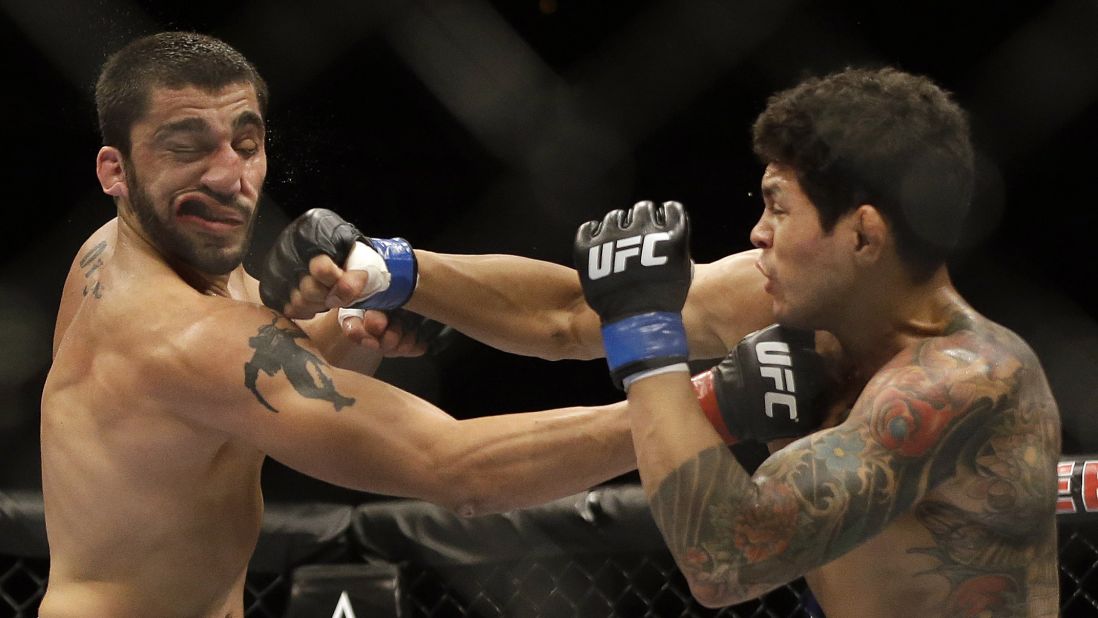 Diego Ferreira, right, punches Ramsey Nijem during their mixed martial arts bout Saturday, August 30, at UFC 177 in Sacramento, California. Ferreira won by a second-round knockout.