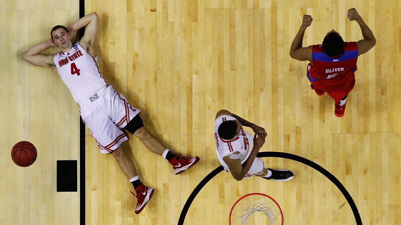 Ohio State point guard Aaron Craft, left, lies on the court after missing a shot to beat Dayton during their NCAA Tournament game on Thursday, March 20.