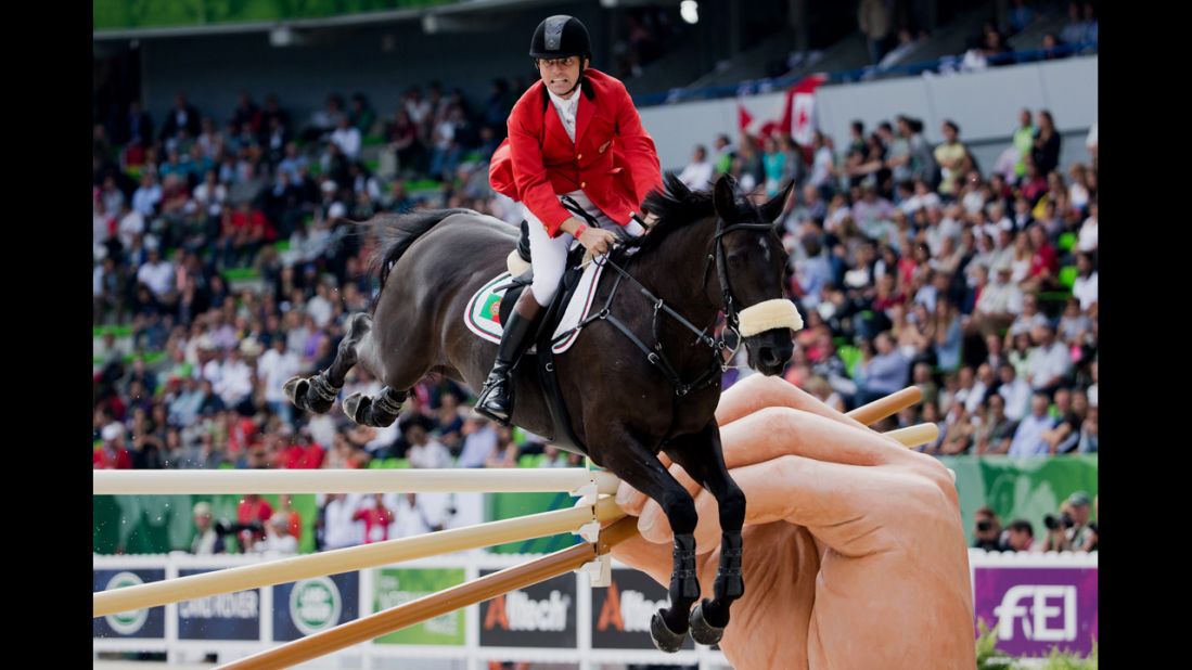 Norbert Ell clears a hurdle with his horse T-Quinta during the World Equestrian Games on Wednesday, September 3.