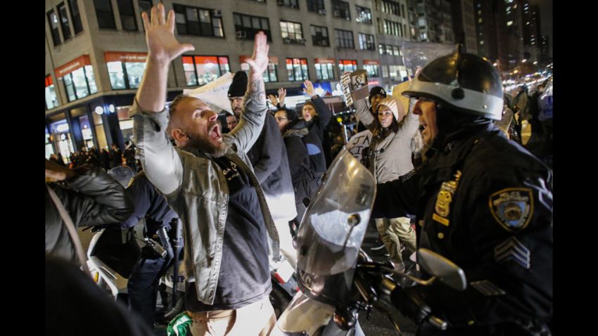 NEW YORK, NY - DECEMBER 3: A man yells at a police officer as he takes part during a protest on 6th Avenue in Manhattan after a grand jury decided not to indict New York Police Officer Daniel Pantaleo in Eric Garner's death on December 3, 2014 in New York City. Eric Garner was killed by a police officer Daniel Pantaleo on July 17, 2014 after Pantaleo suspected him of selling untaxed cigarettes and putting him in a choke hold.  (Photo by Kena Betancur/Getty Images)