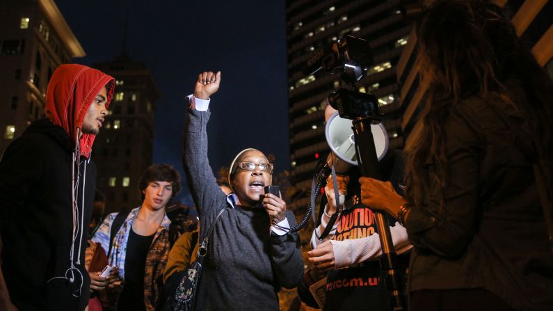 A woman speaks during a demonstration in Oakland on December 3.