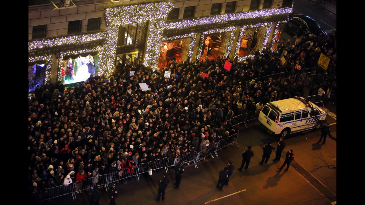 Protesters rally near Rockefeller Center during a ceremony to light the Rockefeller Center Christmas Tree in New York.