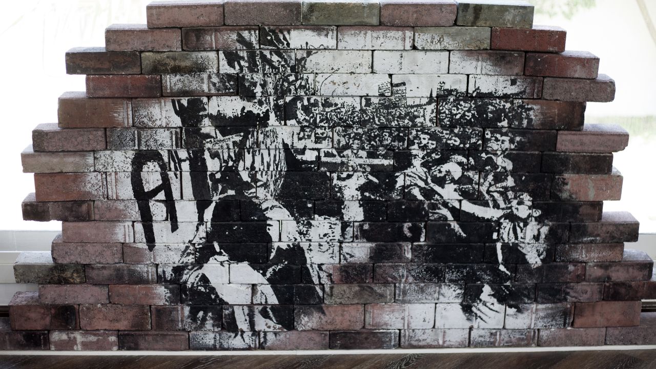 Street art on brick walls highlight graffiti's urban roots.
