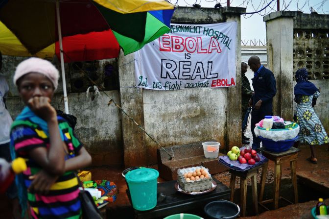 "When someone you love is sick, you want to hold that person, you want to carry them," said Johansen. "But you can't." In Freetown, a sign warning of the dangers of Ebola hangs outside a government hospital.