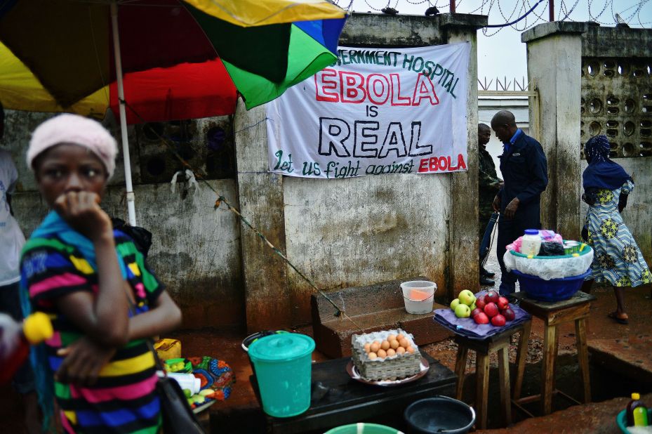"When someone you love is sick, you want to hold that person, you want to carry them," said Johansen. "But you can't." In Freetown, a sign warning of the dangers of Ebola hangs outside a government hospital.