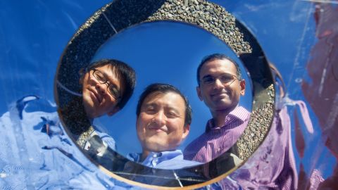 Shanhui Fan (center) and grad students Linxiano Zhu and Aaswatch Raman show off their invention.