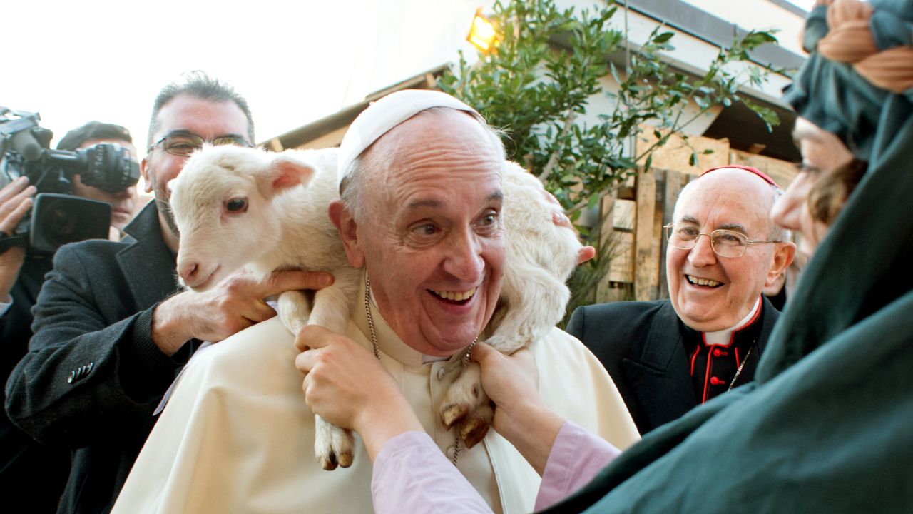 <strong>January 6:</strong> A lamb is placed around the neck of Pope Francis as he visits a living nativity scene near Rome for the Epiphany religious holiday.