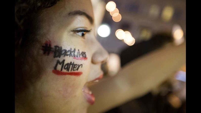 "Black Lives Matter" is written across the cheek of Samaria Muhammad as she chants with fellow protesters in Atlanta on December 4. 