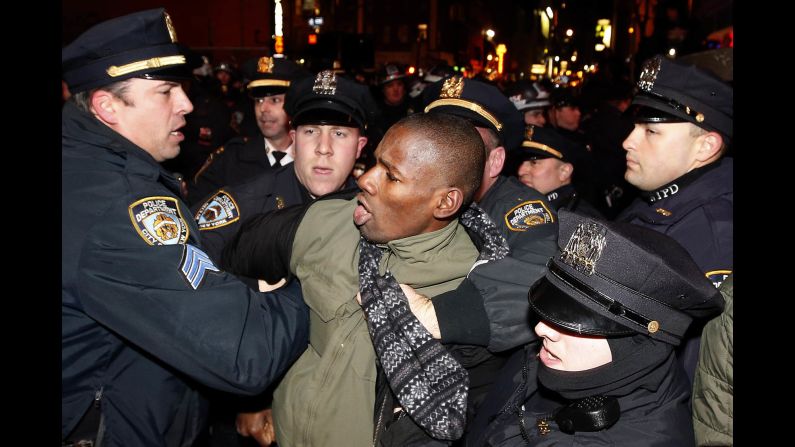 Police make an arrest as protesters march through Manhattan early on December 5.