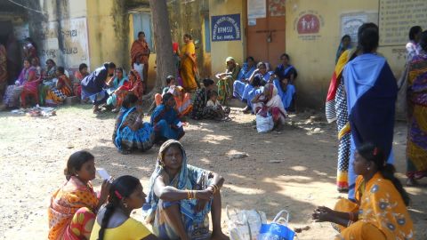 Patients wait outside the medical center where the bicycle pump was used.