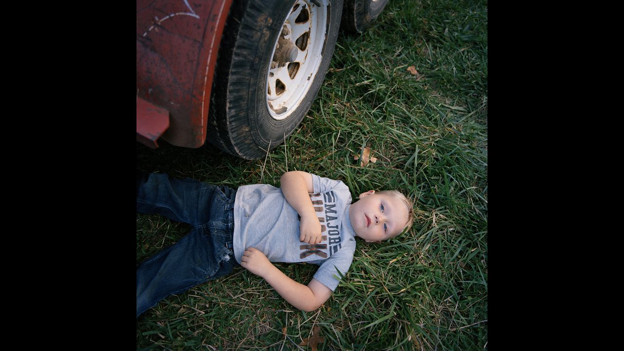 Caleb Patterson, 4, rests beneath a flatbed trailer during a church picnic held near Plato, Missouri, in 2012. Plato is the "mean center of population" for the United States. That means, according to the U.S. Census Bureau, it's the place "where an imaginary, flat, weightless and rigid map of the United States would balance perfectly if all residents were of identical weight."