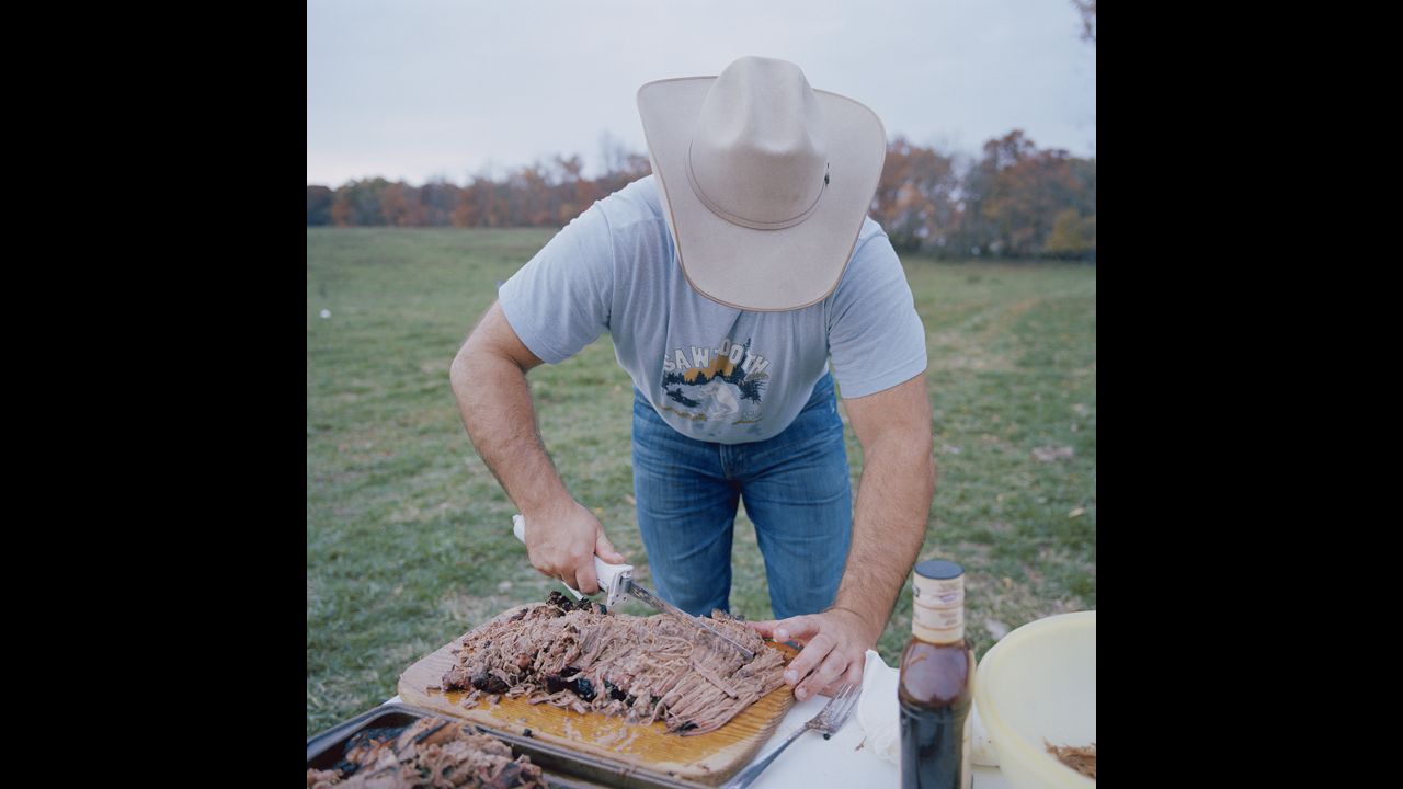 Brandon Davis cuts brisket during a church picnic in Plato, which has a population of only 109.