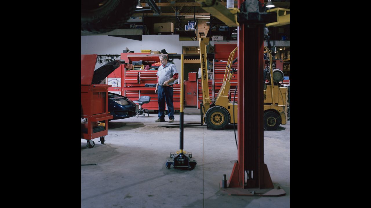 Viktor Arrington works on a car in his auto-repair shop.