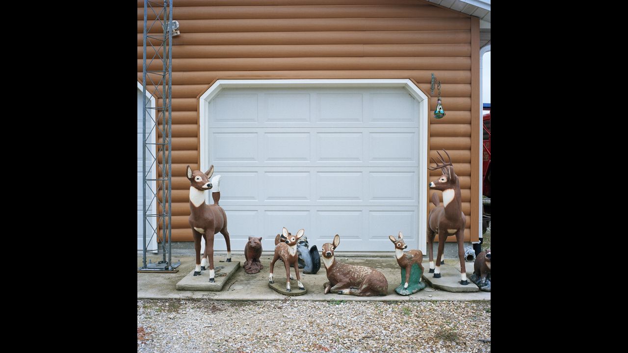 Ceramic lawn ornaments sit in front of Arrington's garage.