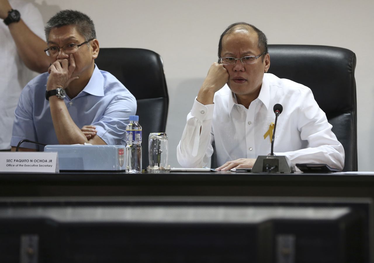 Philippine President Benigno Aquino III, right, and Executive Secretary Paquito Ochoa watch the presentation of officials of the National Disaster Risk Reduction & Management Council in Manila. 