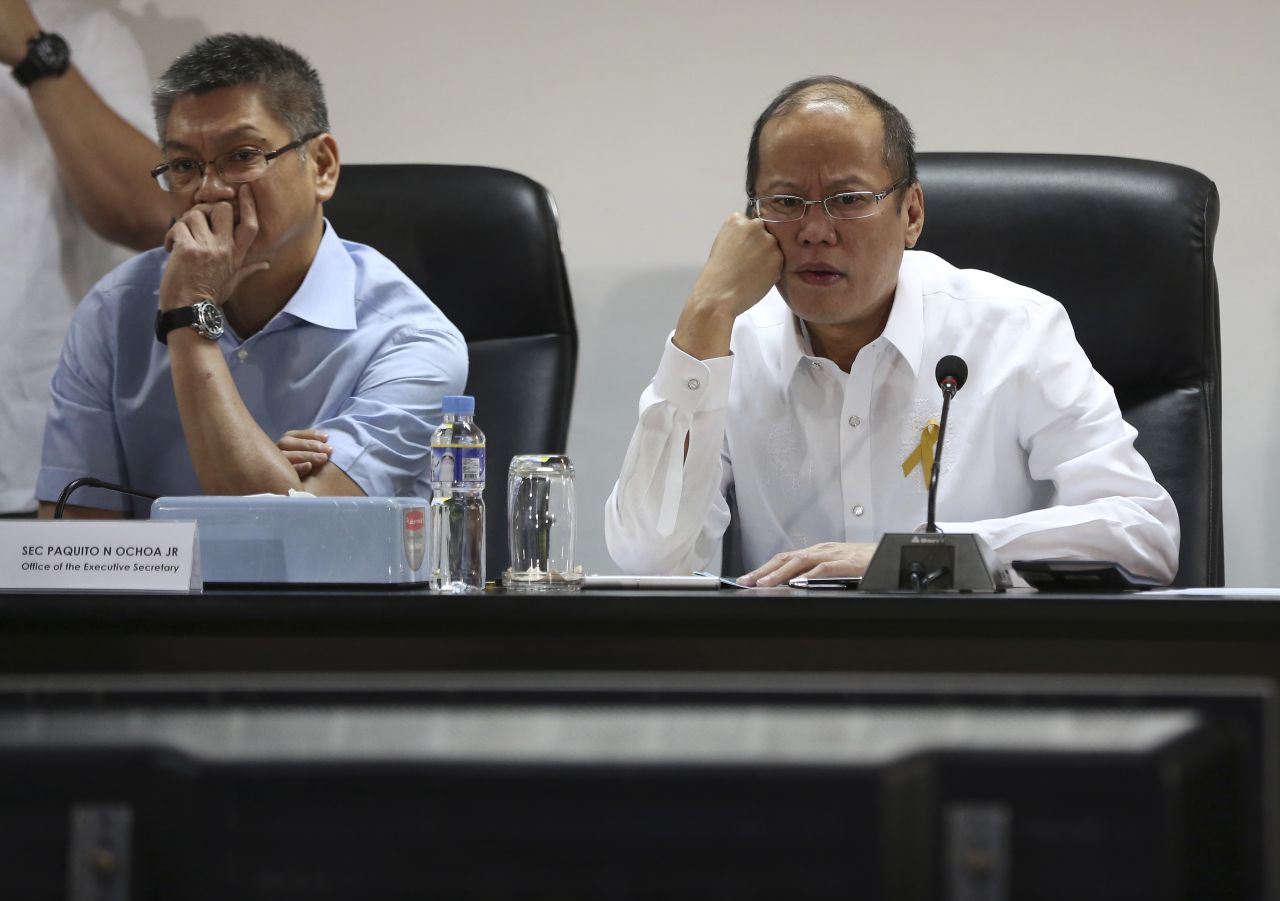 Philippine President Benigno Aquino III, right, and Executive Secretary Paquito Ochoa watch the presentation of officials of the National Disaster Risk Reduction & Management Council in Manila.