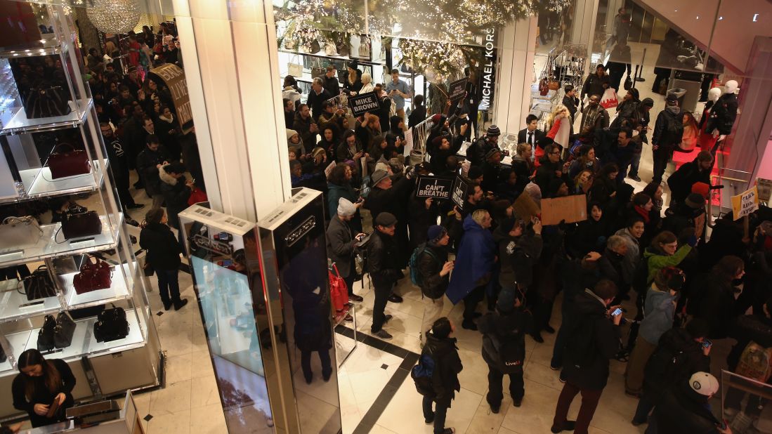 Demonstrators march through a Macy's in Manhattan before staging a "die-in" at the iconic department store on December 5.