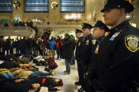 Police stand guard as protesters participate in a "die-in" December 6 at Grand Central Station in New York.