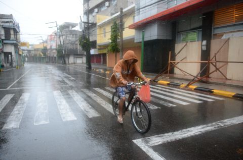 A resident cycles down an empty street before Hagupit passes near Legazpi on December 7.