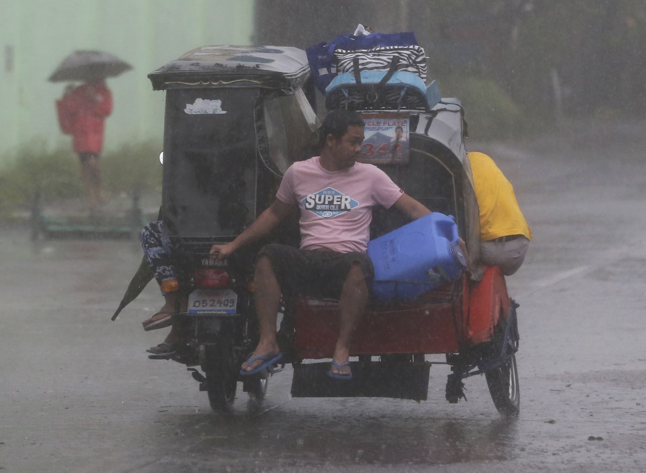 Residents head for an evacuation center on December 7 as strong winds and rains hit Legazpi.