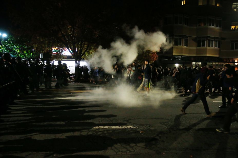 Demonstrators retreat in Berkeley, California, after police deploy tear gas during a <a href="http://www.cnn.com/2014/12/07/justice/protests-grand-jury-chokehold/index.html">protest that turned violent</a> before dawn on December 7.