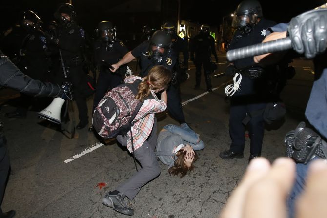 A police officer in Berkeley clashes with a protester on December 7.