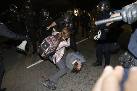 A police officer in Berkeley clashes with a protester on December 7. 