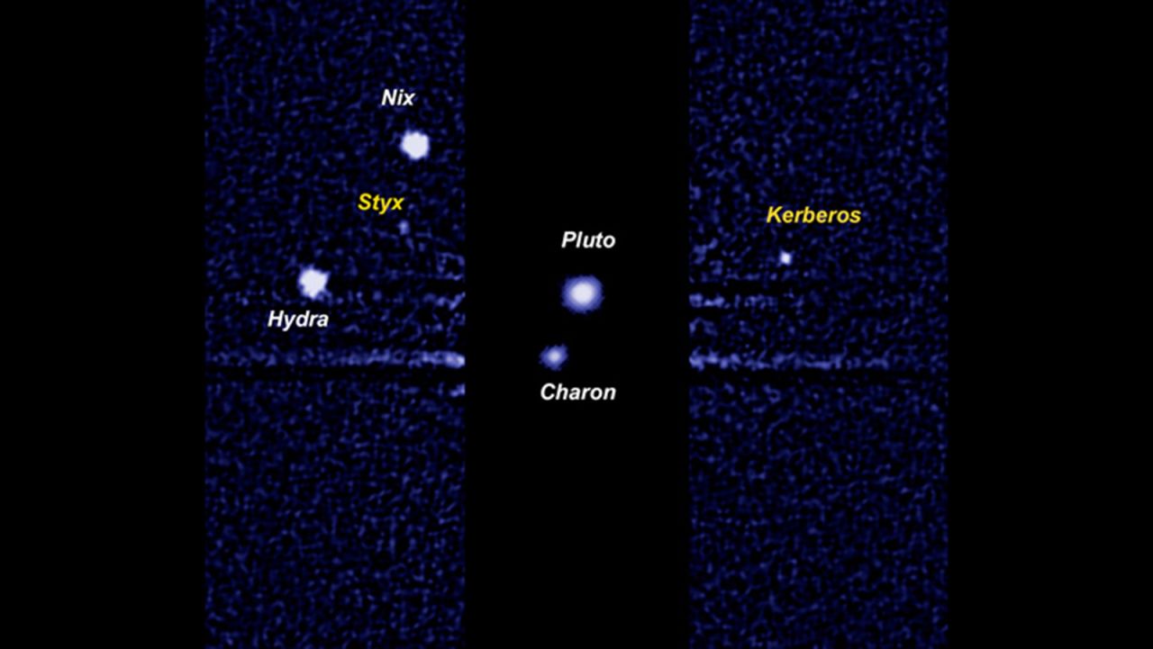 A Hubble Space Telescope image of Pluto and its moons. Charon is the largest moon close to Pluto. The other four bright dots are smaller moons discovered in 2005, 2011 and 2012: Nix, Hydra, Kerberos and Styx.