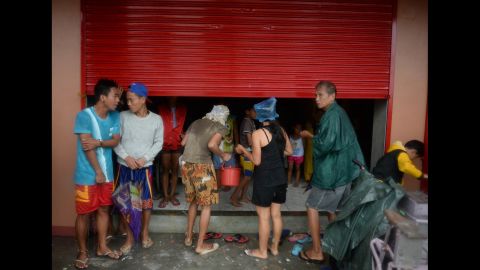 Residents take shelter in an unfinished building hours before Hagupit passes near Legazpi on December 7.