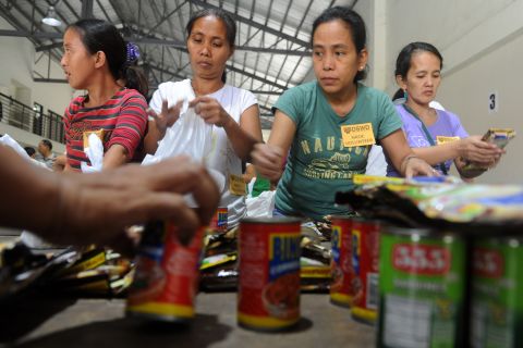 Volunteers repack relief goods in Manila on December 7.