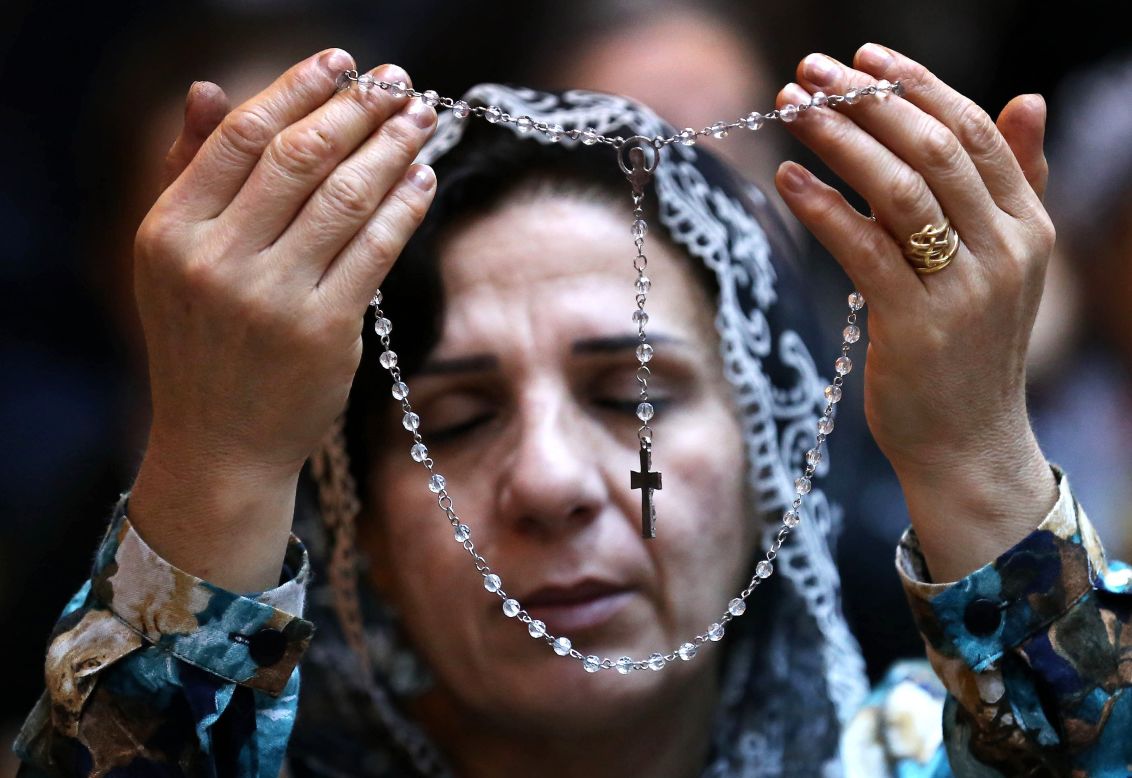 DECEMBER 8 - IRBIL, IRAQ: A Christian prays during a visit by the Archbishop of Lyon, French Cardinal Philippe Barbarin, at the Saint Joseph church in the capital of the Kurdish region of northern Iraq.