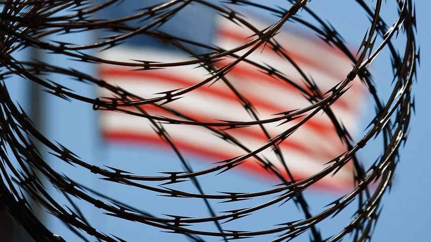 GUANTANAMO BAY, CUBA - OCTOBER 27: (EDITORS NOTE: Image has been reviewed by U.S. Military prior to transmission.) A roll of protective wire rings a detainee camp inside the U.S. military prison for 'enemy combatants' on October 27, 2009 in Guantanamo Bay, Cuba. Although U.S. President Barack Obama pledged in his first executive order last January to close the infamous prison within a year's time, the government has been struggling to try the accused terrorists and to transfer them out ahead of the deadline. Military officials at the prison point to improved living standards and state of the art medical treatment available to detainees, but the facility's international reputation remains tied to the 'enhanced interrogation techniques' such as waterboarding employed under the Bush administration. (Photo by John Moore/Getty Images)