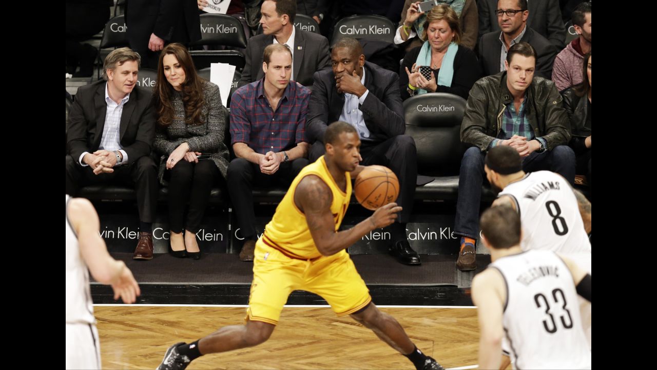 Prince William sits with former NBA star Dikembe Mutombo during the game.