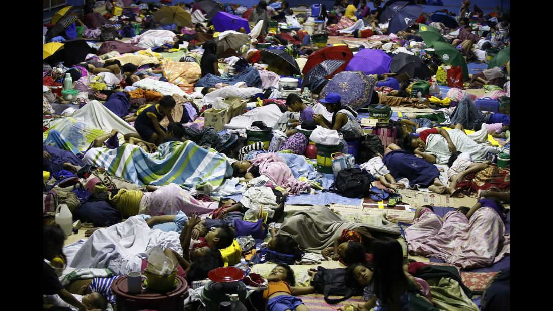 People seek refuge inside a temporary evacuation center in Quezon City, Philippines, on Tuesday, December 9. Typhoon Hagupit tore apart homes and sent waves crashing through coastal communities across the eastern Philippines.
