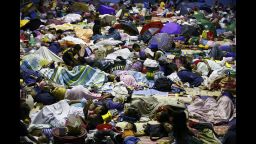People seek refuge inside a temporary evacuation center in Quezon City, Philippines, on Tuesday, December 9.