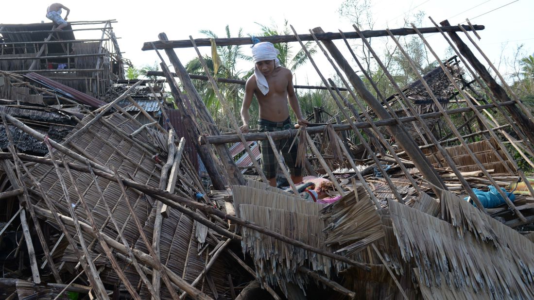 Residents try to salvage materials from destroyed houses in San Julian, Philippines, on December 9.