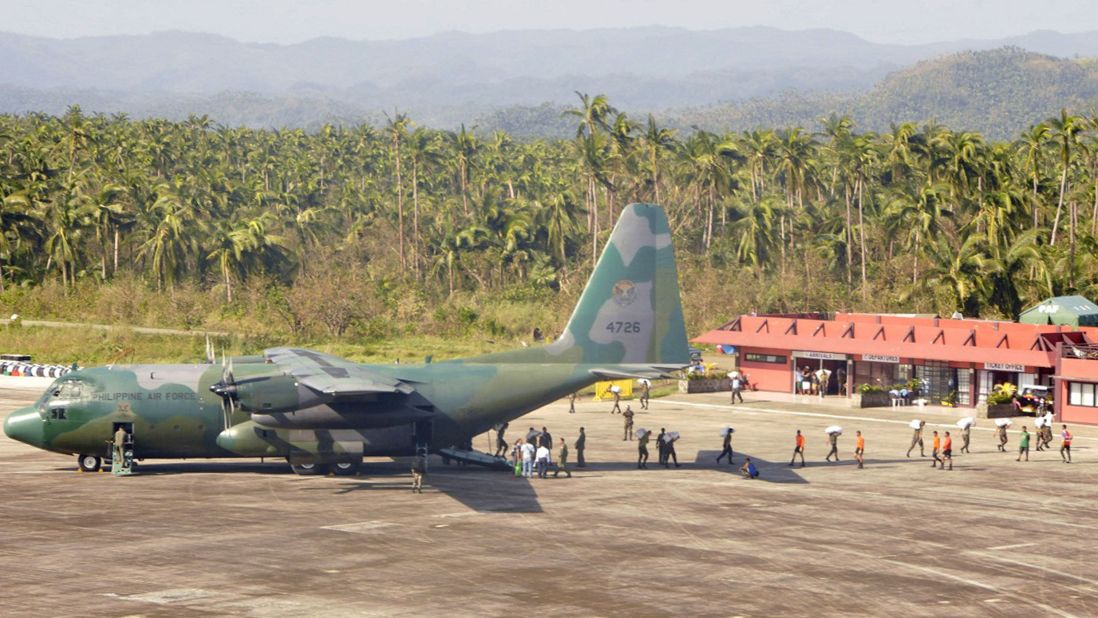 A Philippine air force cargo plane unloads tons of relief supplies in Borongan, Philippines, on December 9.