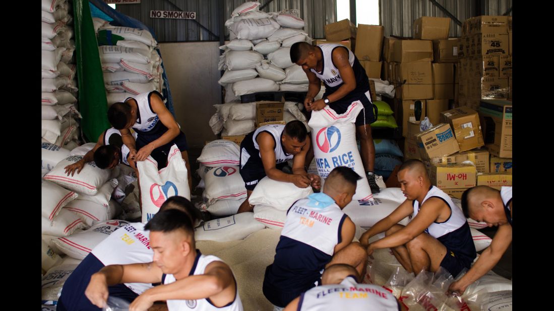 Philippine navy personnel pack rice packages at a government distribution center in Manila, Philippines, on December 8.