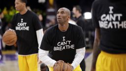 Los Angeles Lakers' Kobe Bryant, center, warms up before an NBA basketball game against the Sacramento Kings, Tuesday, Dec. 9, 2014, in Los Angeles. Several athletes have worn "I Can't Breathe" shirts during warm ups in support of the family of Eric Garner, who died July 17 after a police officer placed him in a chokehold when he was being arrested for selling loose, untaxed cigarettes. (AP Photo/Jae C. Hong/AP)