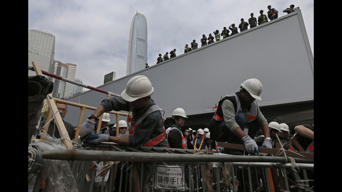 Workers clear barricades on December 11. Protesters wanted to pressure the government to allow open elections for Hong Kong's chief executive in 2017.