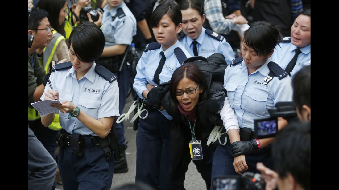 Police officers take away a protester December 11.