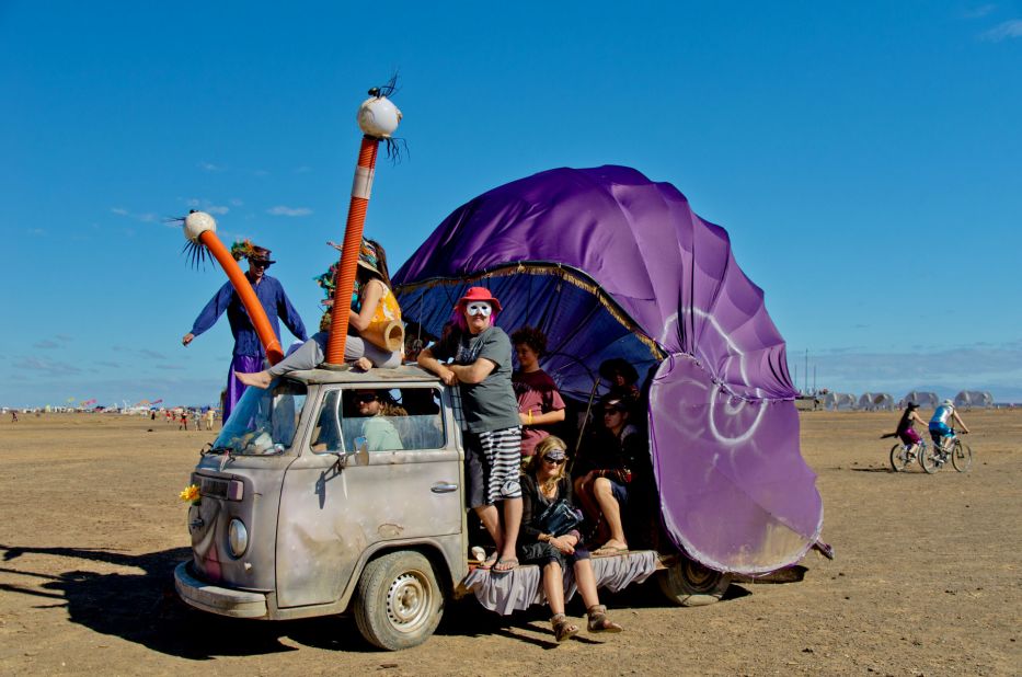 Many people bring bicycles to get around the huge festival site. Others arrive in weird customized vehicles like this this big, purple snail.