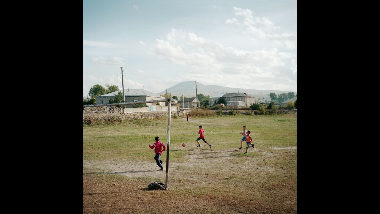 Children play on a soccer field in the village.