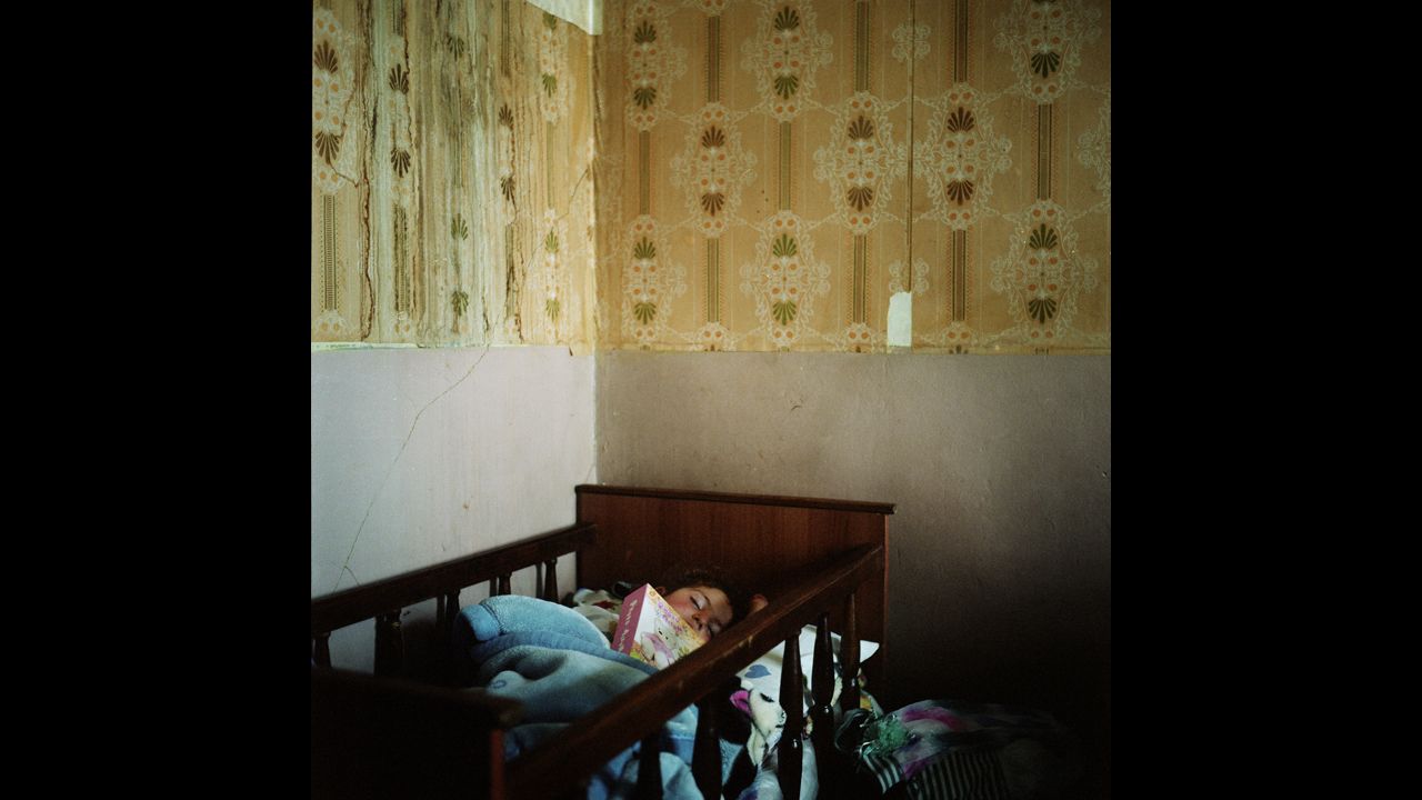 Lilith, Anoush's daughter, fell asleep with her father's photo album. He went to Russia to earn money so they could build a house in the village.