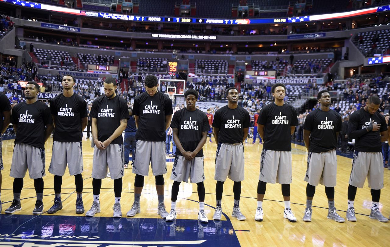 Members of the Georgetown basketball team wear "I can't breathe" shirts as they stand for the national anthem before a home game Wednesday, December 10, in Washington. The shirt references the words spoken by Eric Garner, a 43-year-old man who died earlier this year after being put in a chokehold by a New York City police officer. After a grand jury decided not to bring criminal charges against the officer, demonstrators across the country <a href="http://www.cnn.com/2014/12/04/us/gallery/eric-garner-protests/index.html" target="_blank">took to the streets</a> to express their outrage.