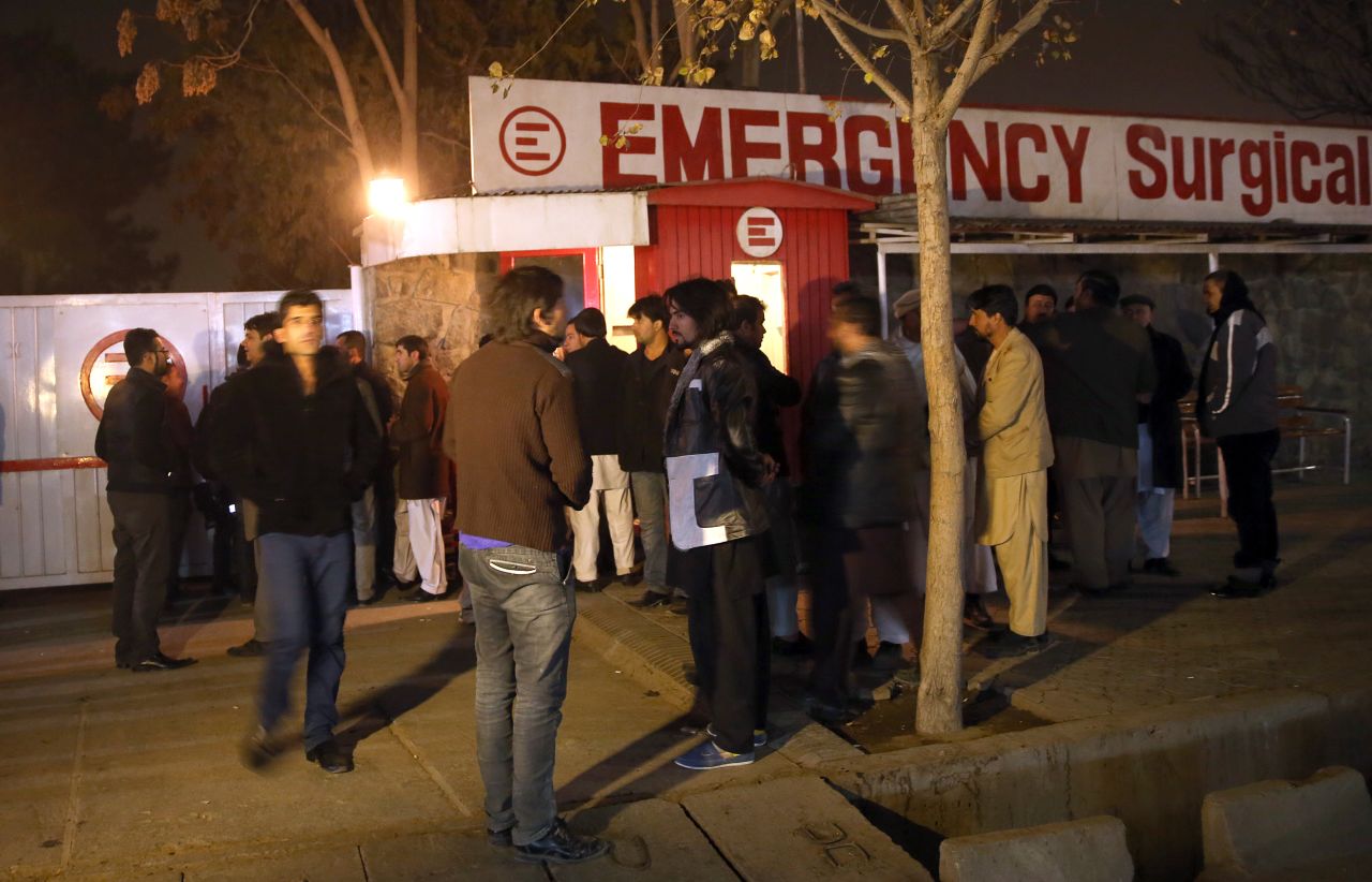Afghans wait outside of a hospital where victims where taken. 