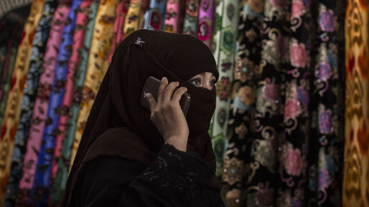A Uyghur woman wears a veil as she shops at a local market on August 2, 2014 in Kashgar, Xinjiang Uyghur Autonomous Region, China.