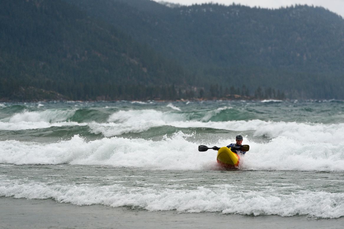 Pete DeLosa paddles his kayak through tall waves on Lake Tahoe, kicked up by a strong storm moving across California and Nevada on December 11.